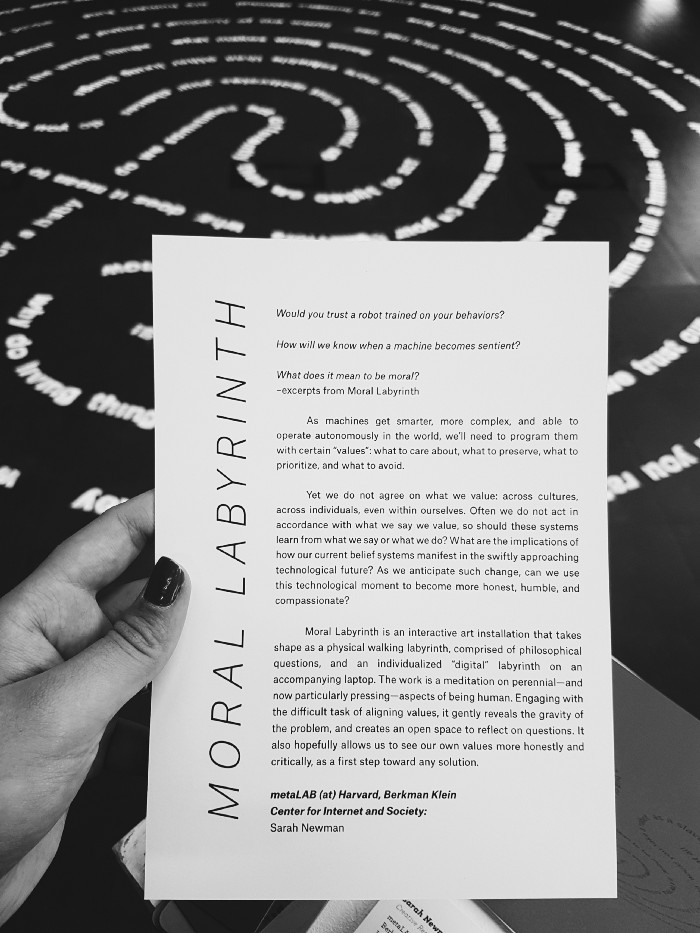 Photograph of the Moral Labyrinth leaflet along with its correspondent an art installation.