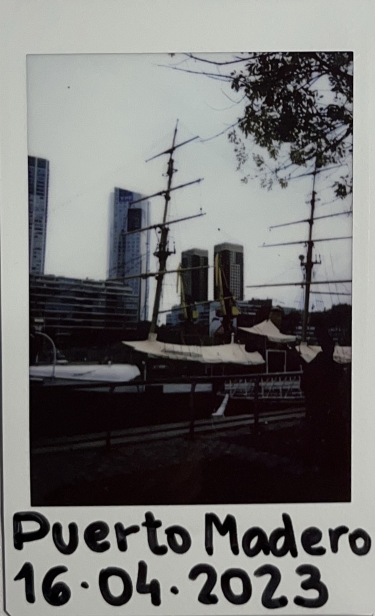 A photograph in Instax film of a ship ancored at Puerto Madero.